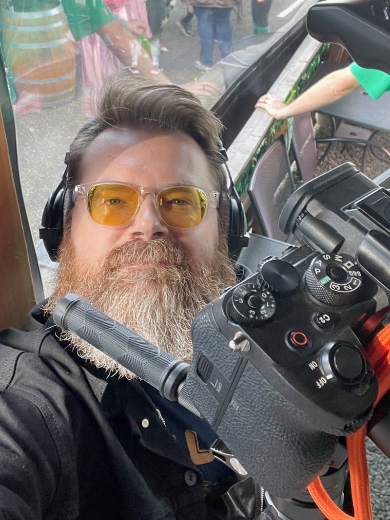 Frank Charlton with camera and headphones on location